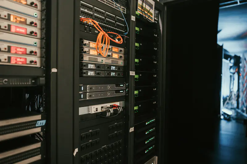 Rack-mounted equipment in a dimly lit equipment room