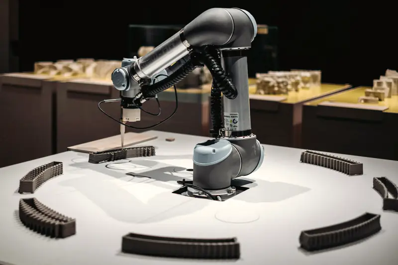 A collaborative robot arm working on a table in a studio